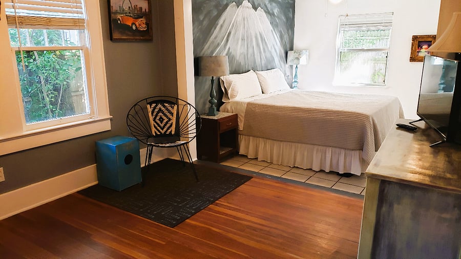 Sunken king-sized bedroom with streaming TV.