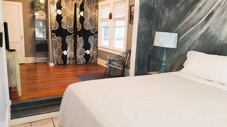 Sunken king-sized bedroom with streaming TV.