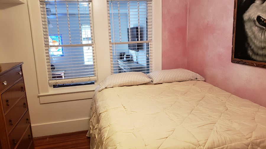 Cheerful bedroom with comfortable queen-sized bed.