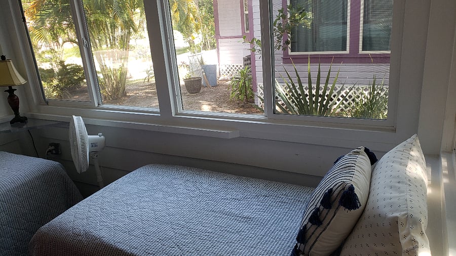 Beautiful Florida sunroom sleeping with two twin beds.