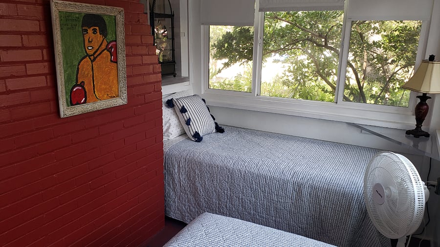 Beautiful Florida sunroom sleeping with two twin beds.
