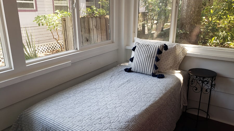 Beautiful Florida sunroom sleeping with two twin beds.