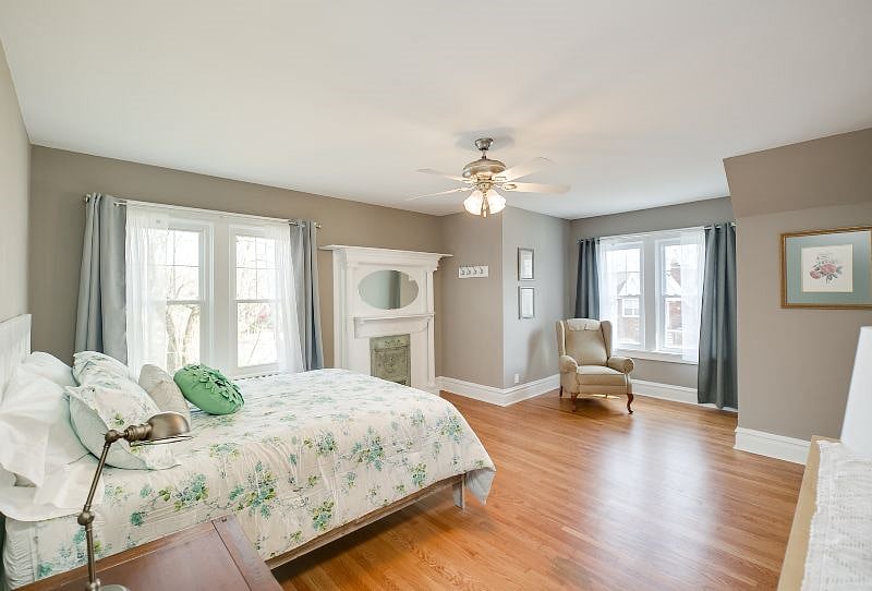 Main bedroom #201, queen sized bed, dresser, closet and seating nook.