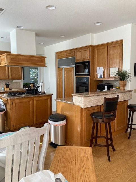 Full kitchen complete with walk-in pantry, double oven, toaster oven, microwave, gas stove, dishwasher, refrigerator and freezer.