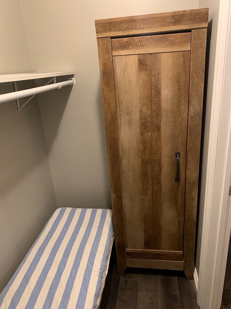 walk in closet with storage closet for linen or used as a dresser