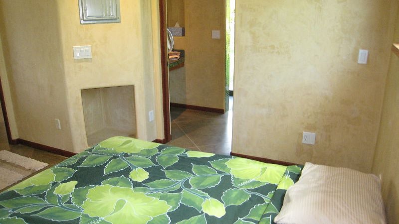 Bedroom / bath featuring glass mosaic and lava garden shower