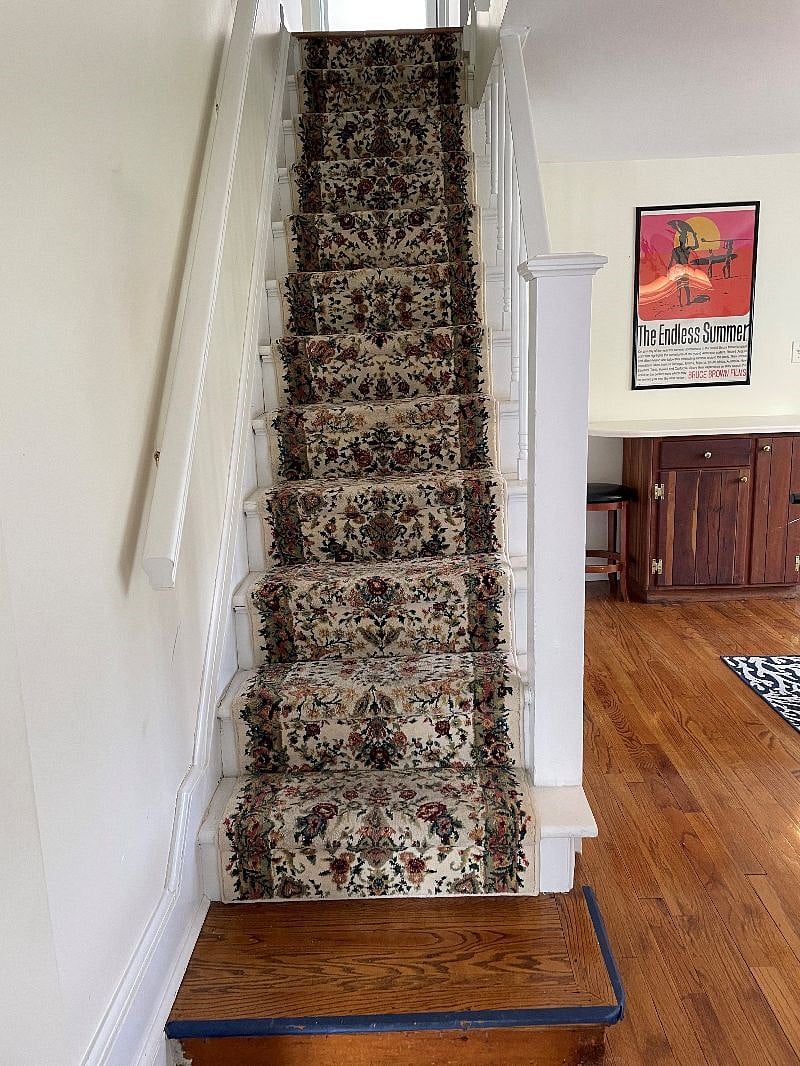 Stairs with railings on both sides to the second floor. A "step down" is necessary to access one bedroom and the second hallway.