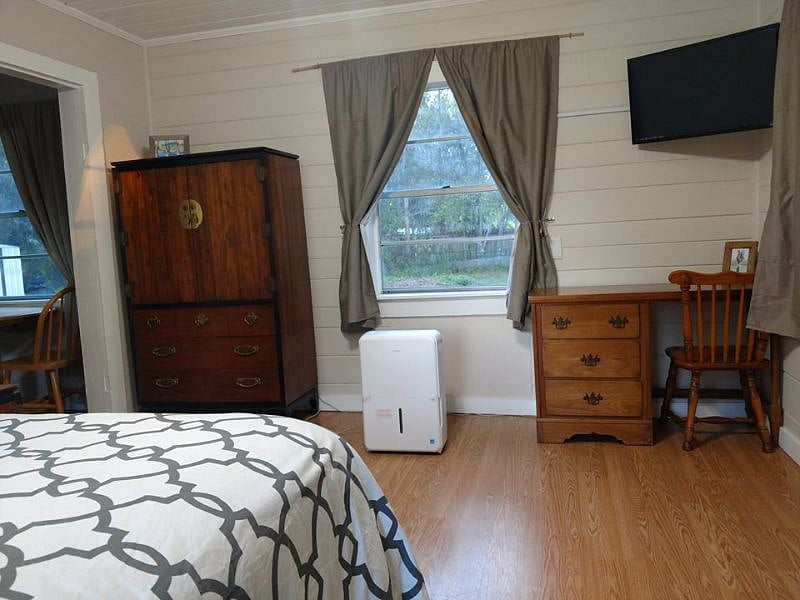 Front room has queen sized bed, desk, smart TV and wardrobe.