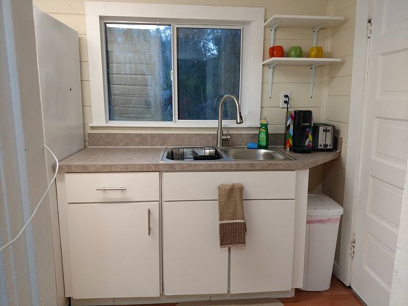 Kitchen sink, coffee maker and toaster.