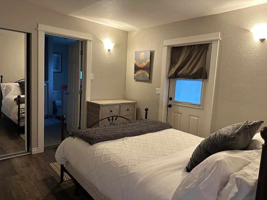 Unit C Bedroom with door to private patio and shared yard.
