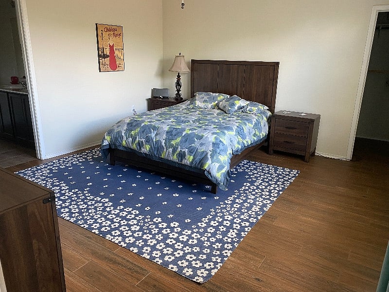 Master bedroom with queen-size bed and attached full master bathroom. Large, roomy closet.