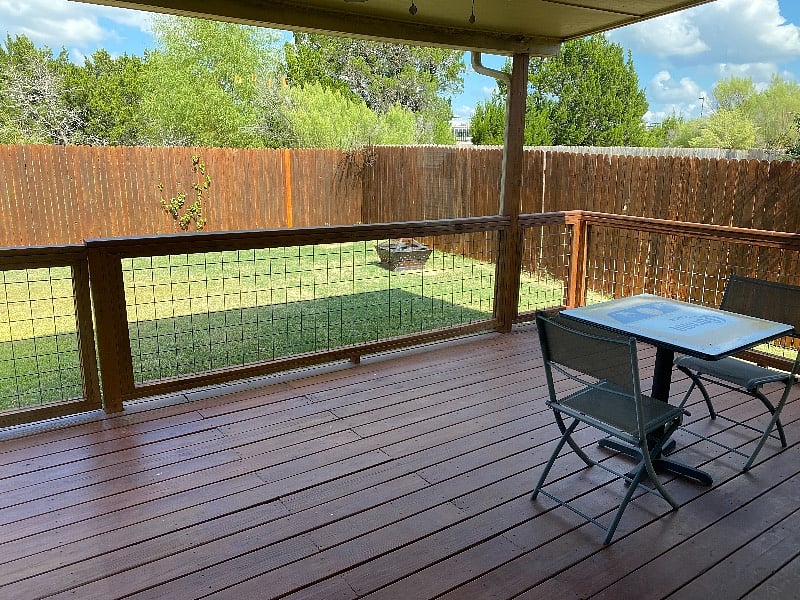 Covered porch area with grill, solid fenced-in private backyard. 