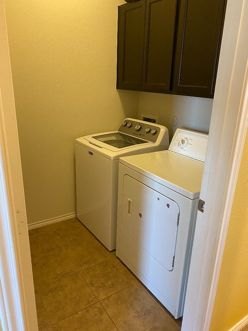 Full laundry room with large-capacity washer and dryer. 