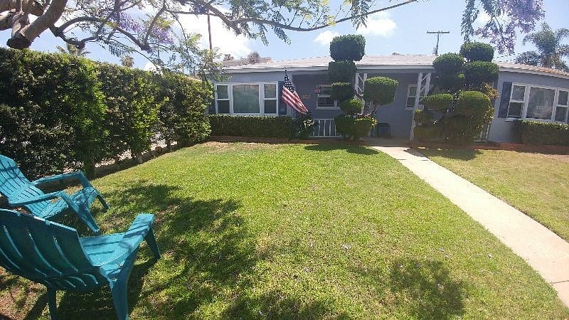 In the common front yard, surrounded by a 6 foot living green hedge! Locked front gate for privacy.