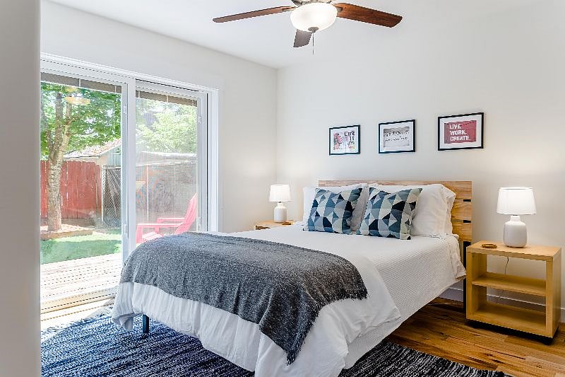 2nd bedroom
downstairs queen bed and glass sliding door leading to fenced backyard