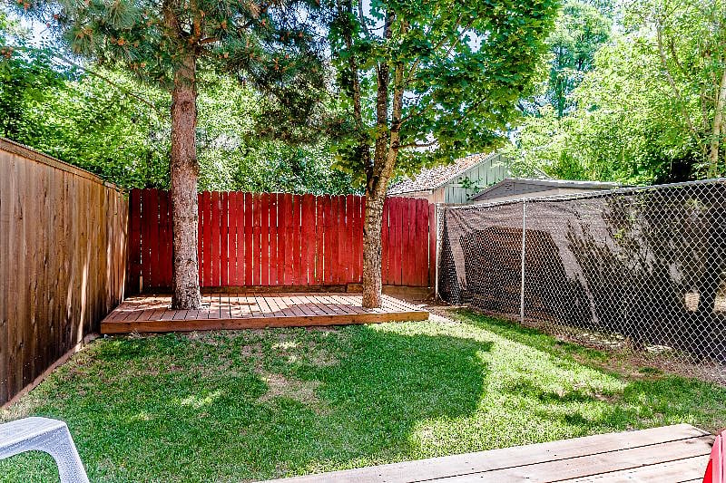 fenced backyard with two wood decks