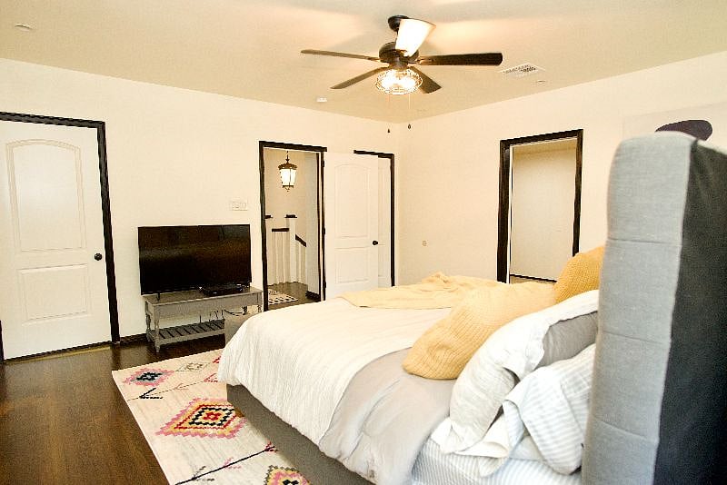 Primary bedroom w/ king sized bed and TV, and private bathroom.
