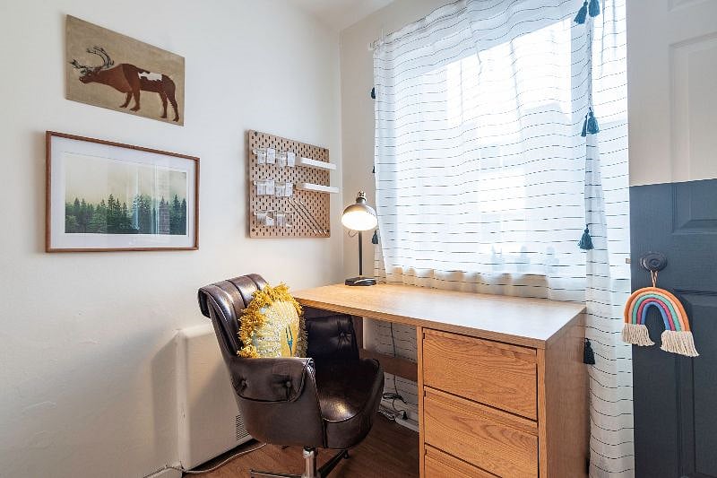 Desk in bedroom. Window looks out to building courtyard below