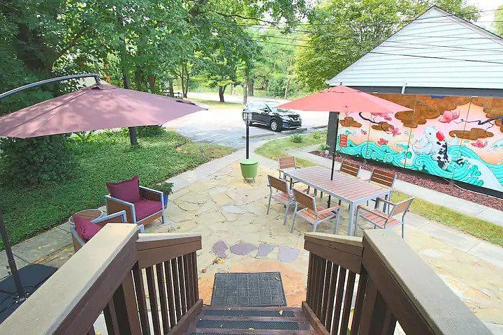 Entrance to The Retreat overlooks a shared outdoor space and parking area.