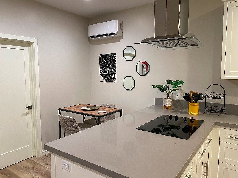 Small kitchenette seating can double as home office space. Remote control A/C unit.