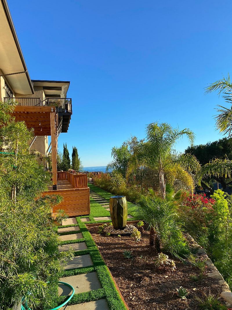Enjoy hummingbirds zipping around the water fountain as you sit by the outdoor fire pit that is adjacent to the deck.