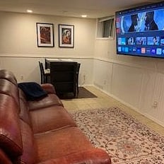 Comfortable leather couch with 67" TV.