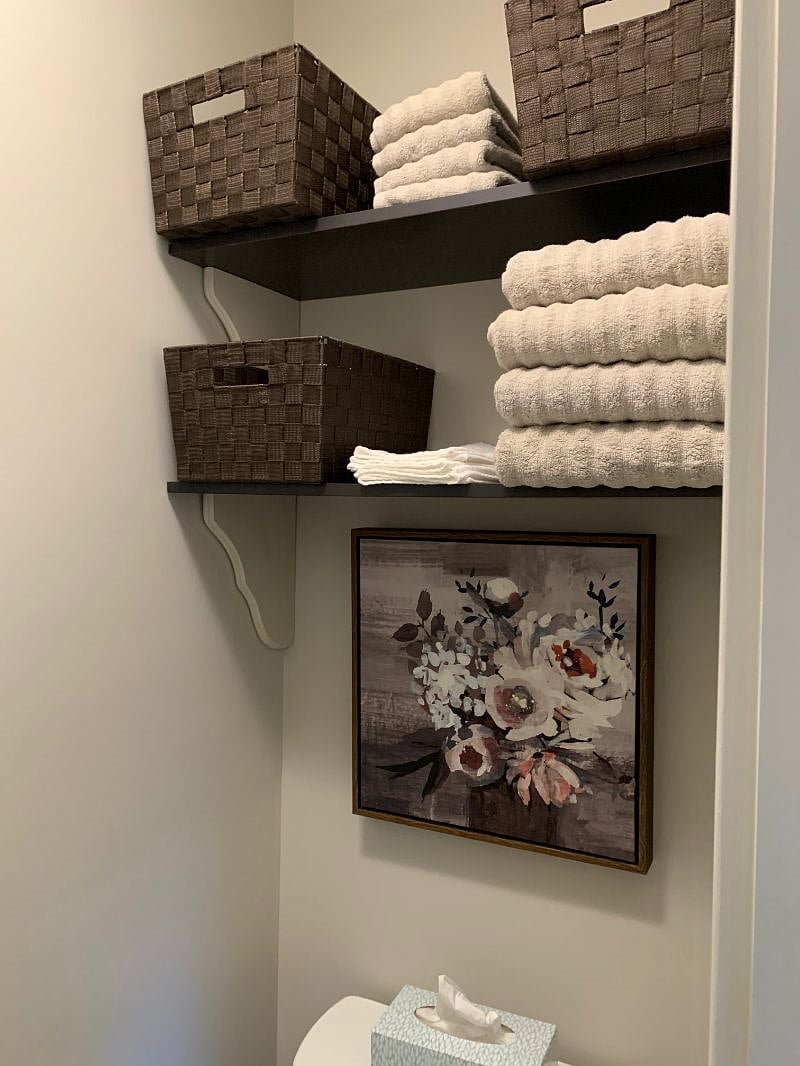 Shelves with basket storage over toilet