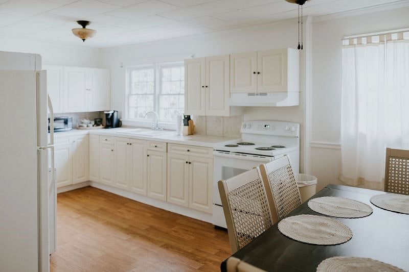 Kitchen is fully stocked with dishes, pots + pans, and basic kitchen utensils 