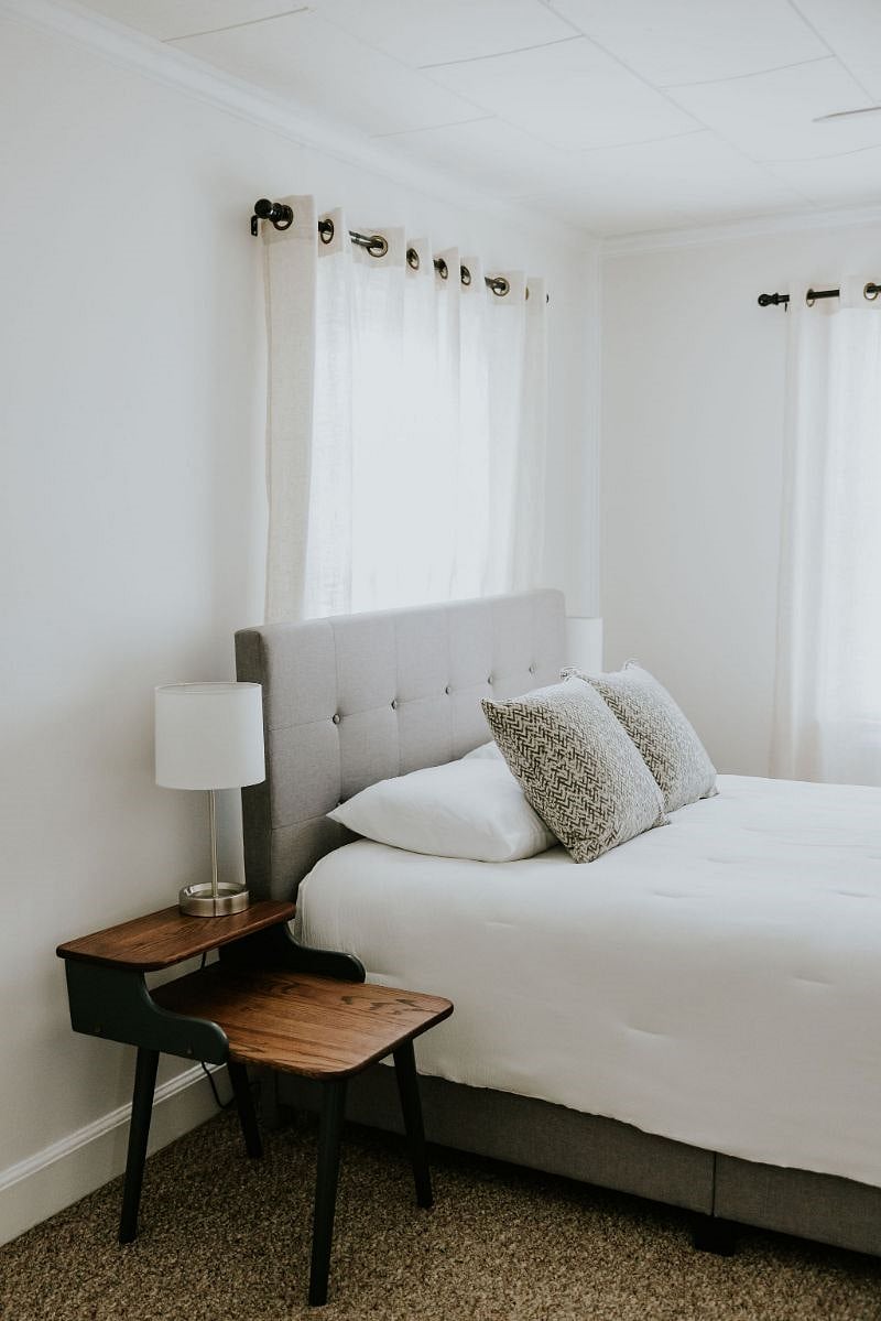 Queen size bedroom with dresser, Roku smart TV, and large closet