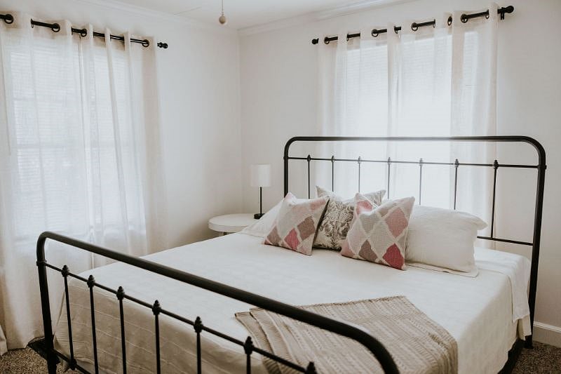 King size bedroom with dresser, Roku smart TV, and large closet