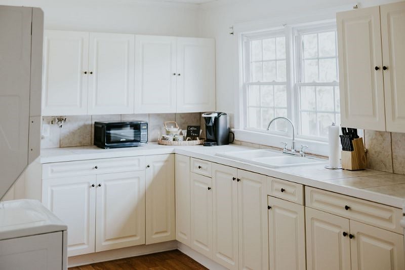 Kitchen has full size refrigerator, stove, microwave, as well as a stackable washer/dryer