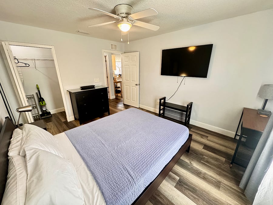 The bedroom includes a 6 drawer dresser, a show organizer, a workspace, 2 nightstands, TV & a large closet.
