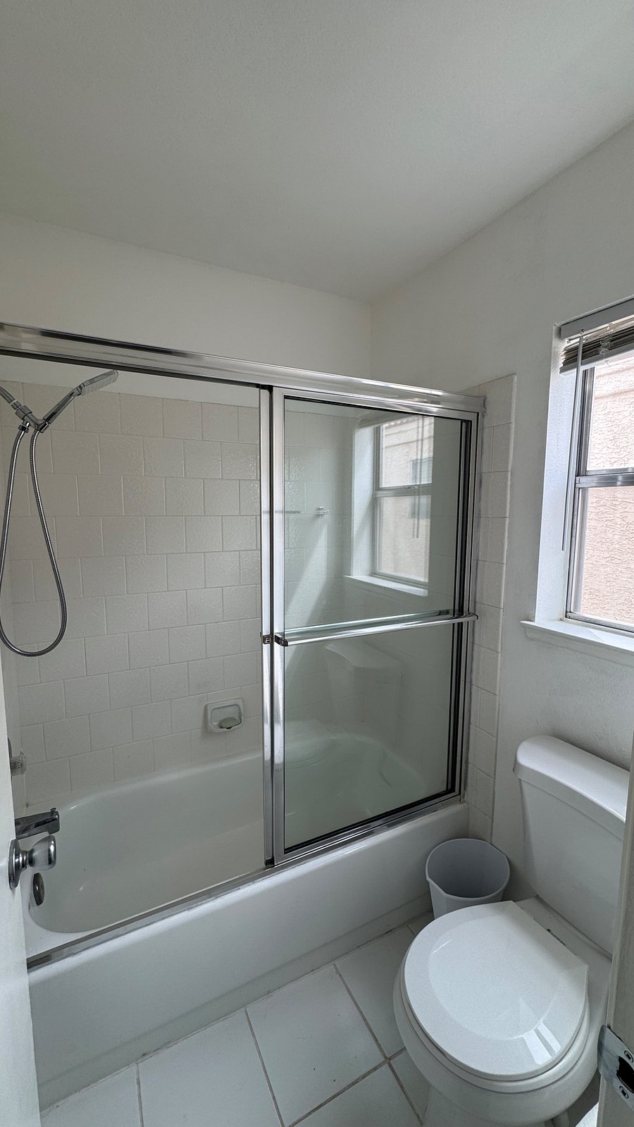 Shower/tub combo with high-pressure shower head. Plenty of natural light. 
