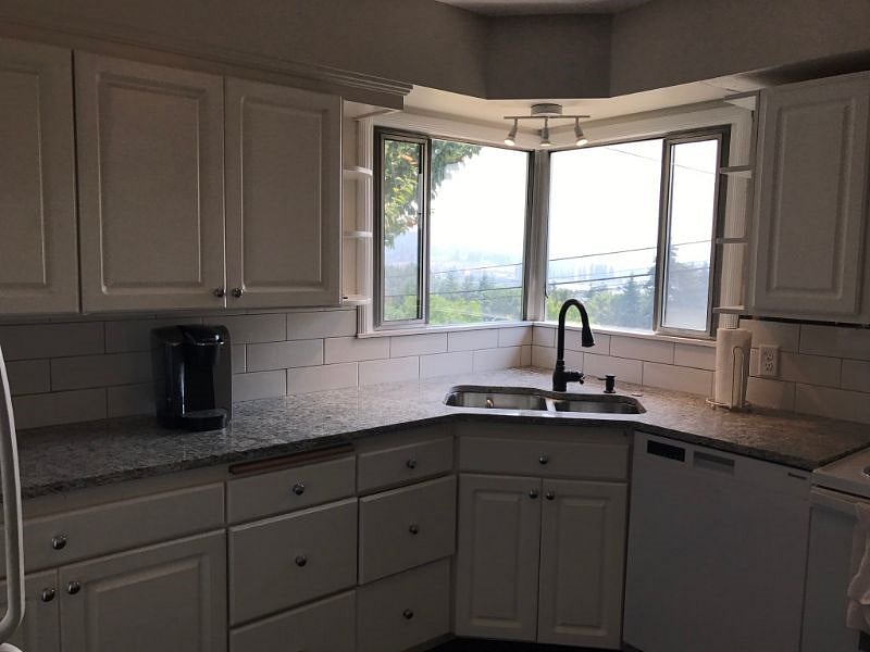 kitchen has new granite countertops, sink, flooring, refrigerator and dishwasher