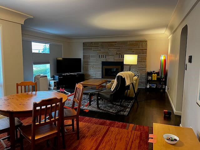 Dining and living rooms. There is a large picture window on the left side which is partially covered by the blinds. Nice views out across the valley with Mt Rainer in the distance.