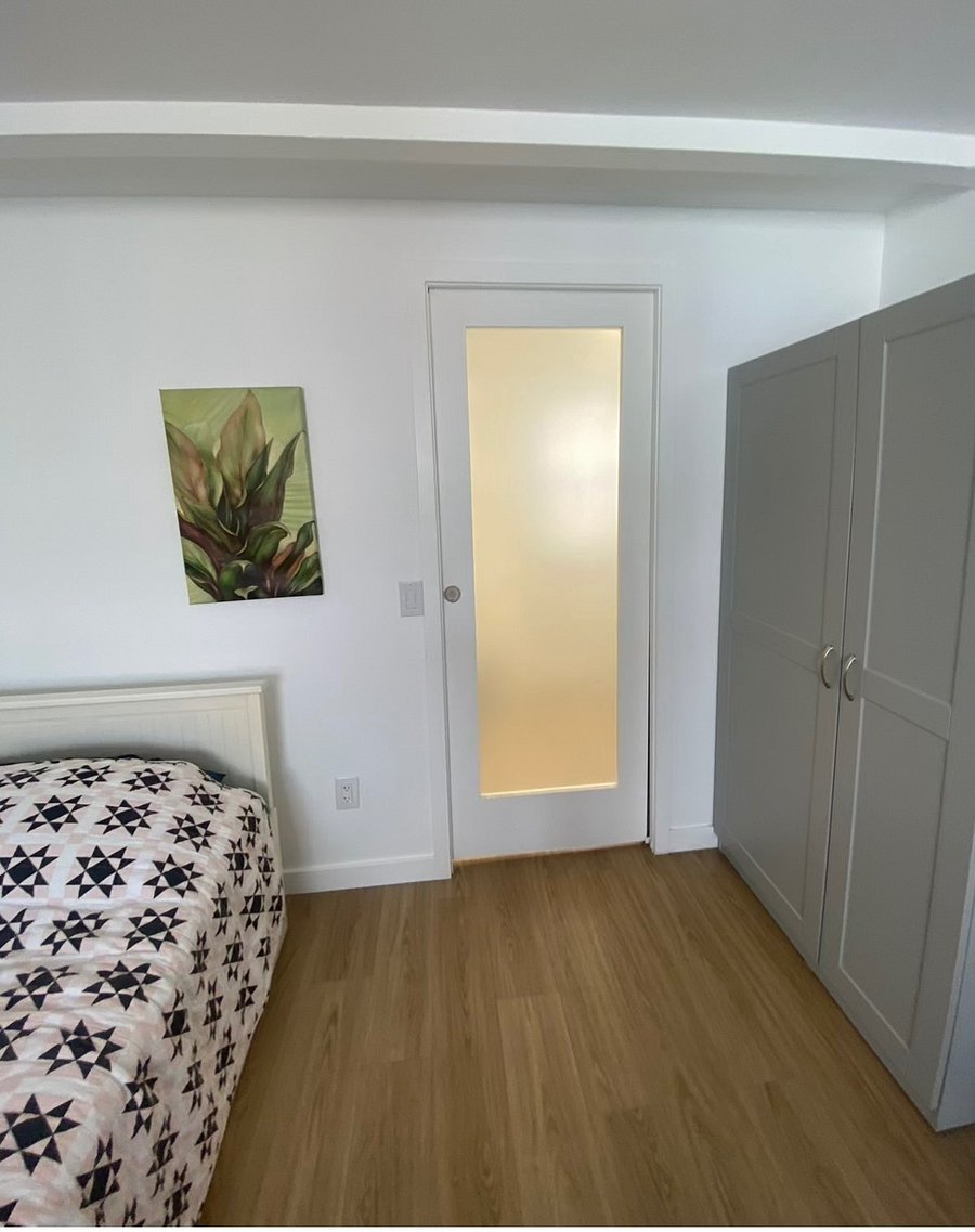 Obscure glass door that opens into bathroom.