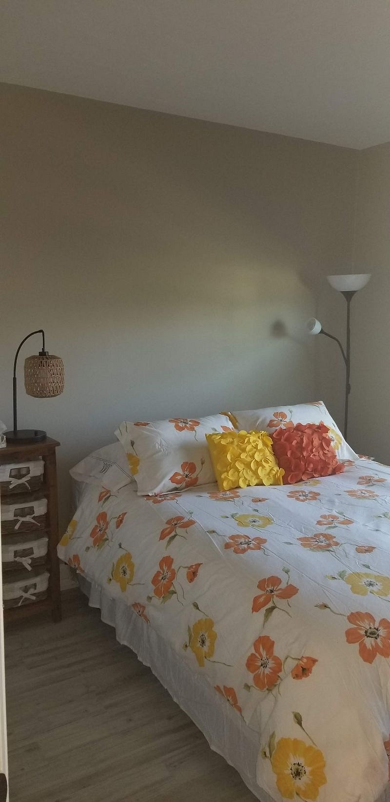 Second bedroom with queen bed and smart tv on top a dresser, plus a closet.