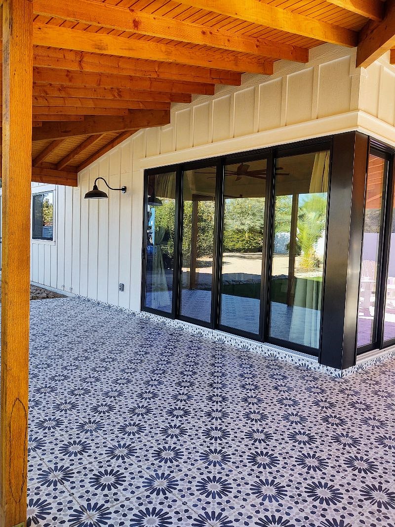North facing patio entrance that looks out to astro turf grass and pool as well as the main house.