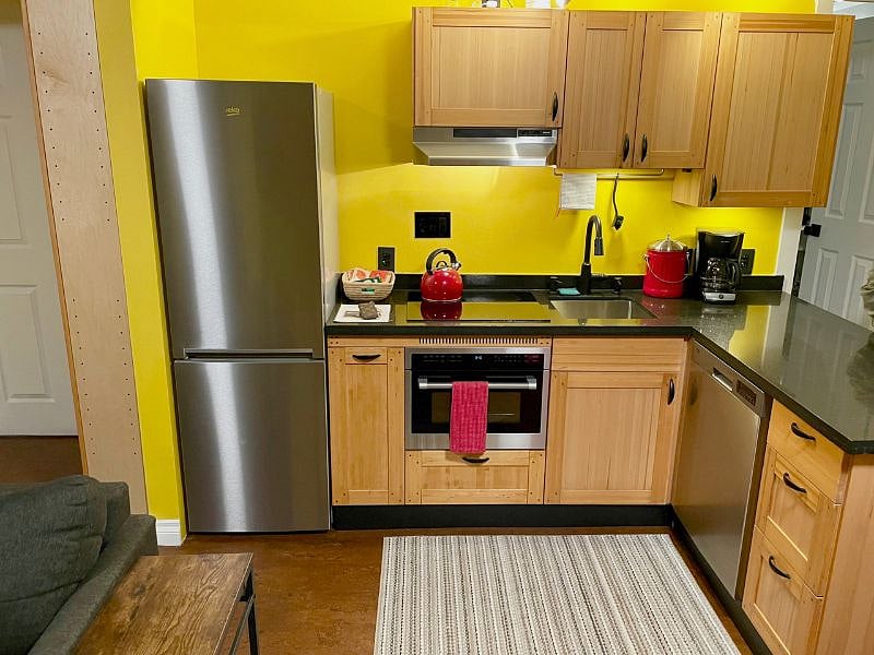 Well equipped kitchen with induction cooktop, wall oven/microwave, dishwasher, toaster and coffee maker.
