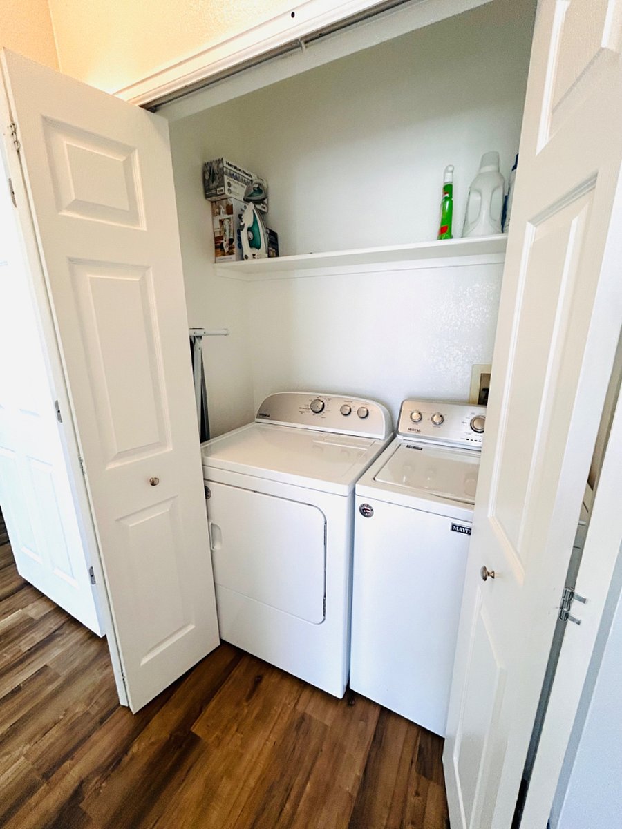 Laundry closet with washer and dryer.
iron/ironing table/steamer also included