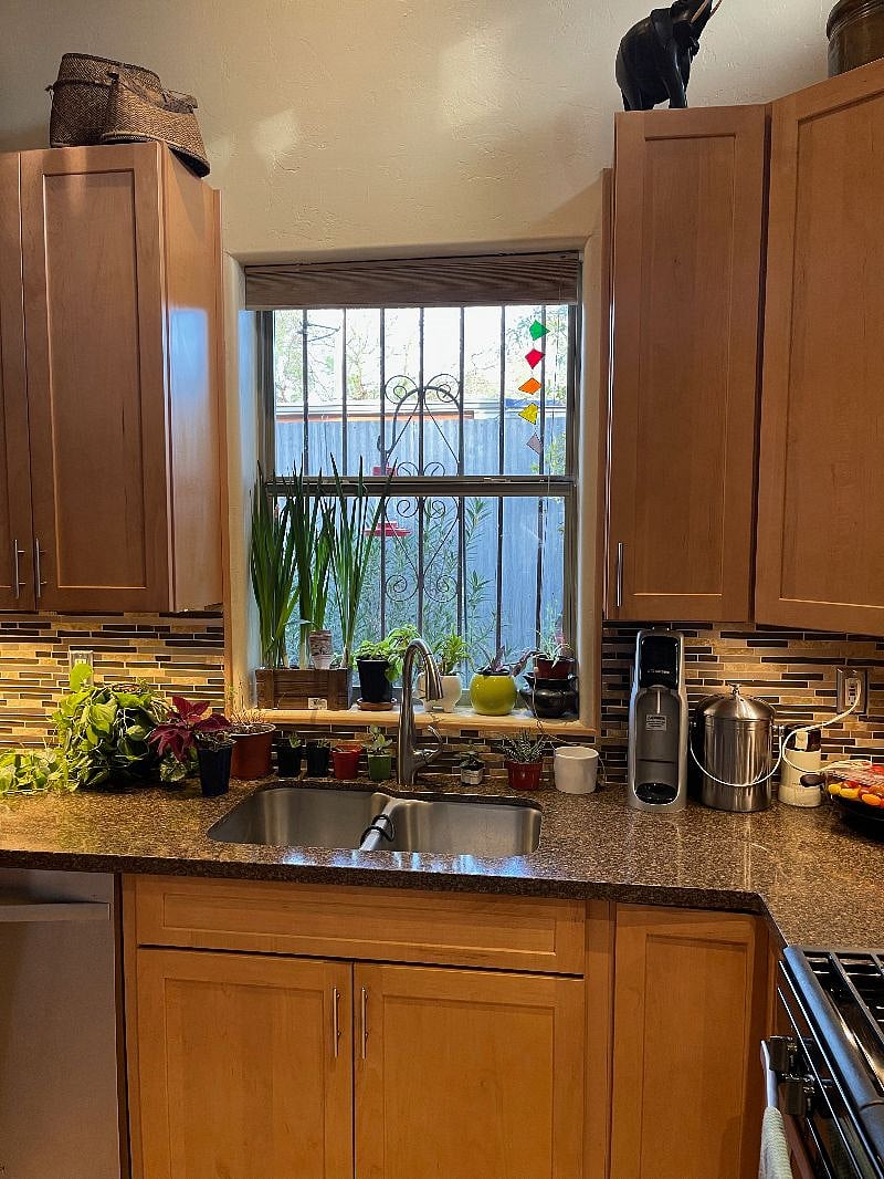 Kitchen window with hummingbird feeder outsideDoo