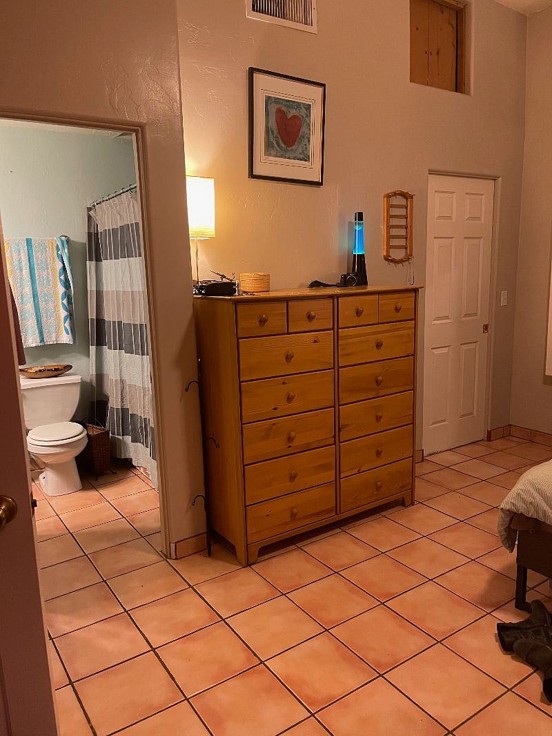 large dresser with walk in closet to the right