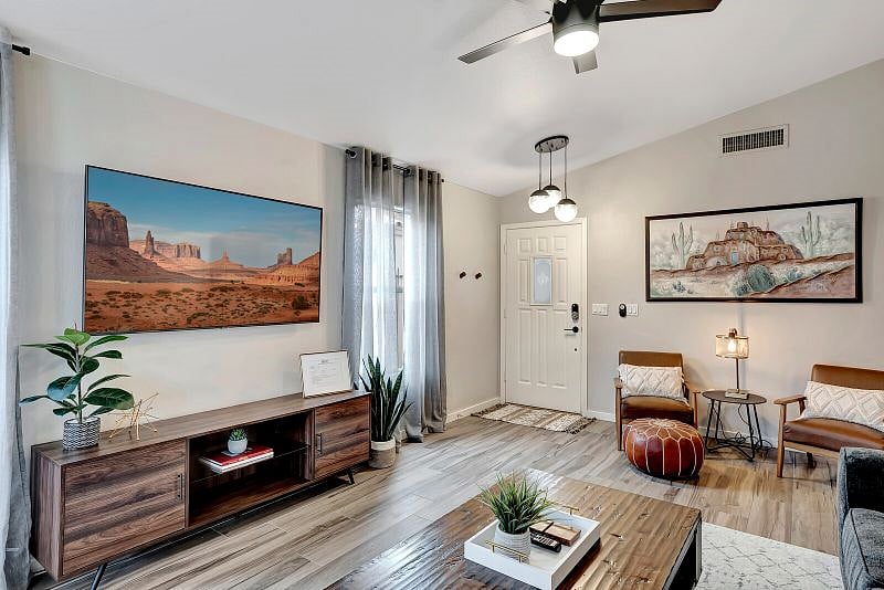 Bright and open living/dining room with 65" Smart TV with YouTube TV subscription.