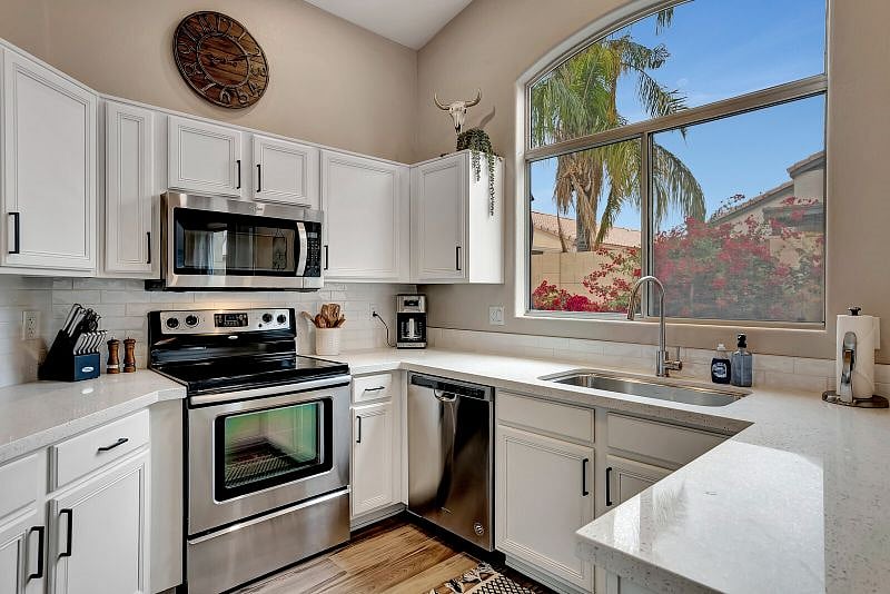 Trendy kitchen features white subway tile, Quartz countertops, Stainless Steel appliances and is fully-stocked for your stay.