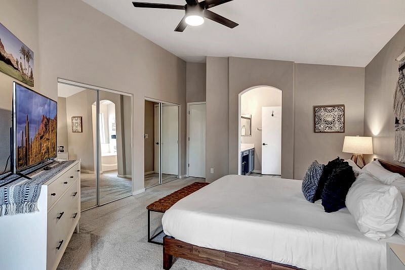 King bedroom with 60" Smart TV with ROKU, backyard access, double closets, and ensuite bathroom.