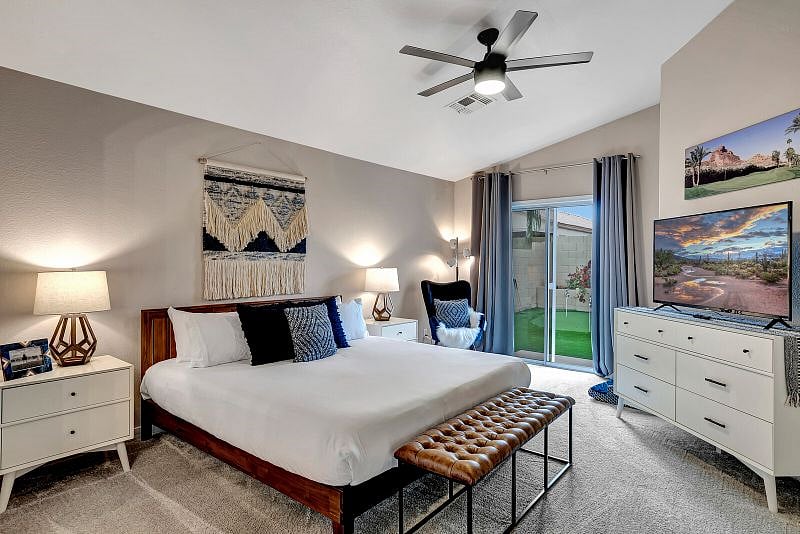 King bedroom with 60" Smart TV with ROKU, backyard access, double closets, and ensuite bathroom.