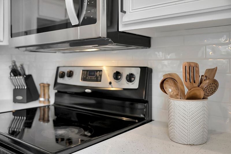 Trendy kitchen features white subway tile, Quartz countertops, Stainless Steel appliances and is fully-stocked for your stay.