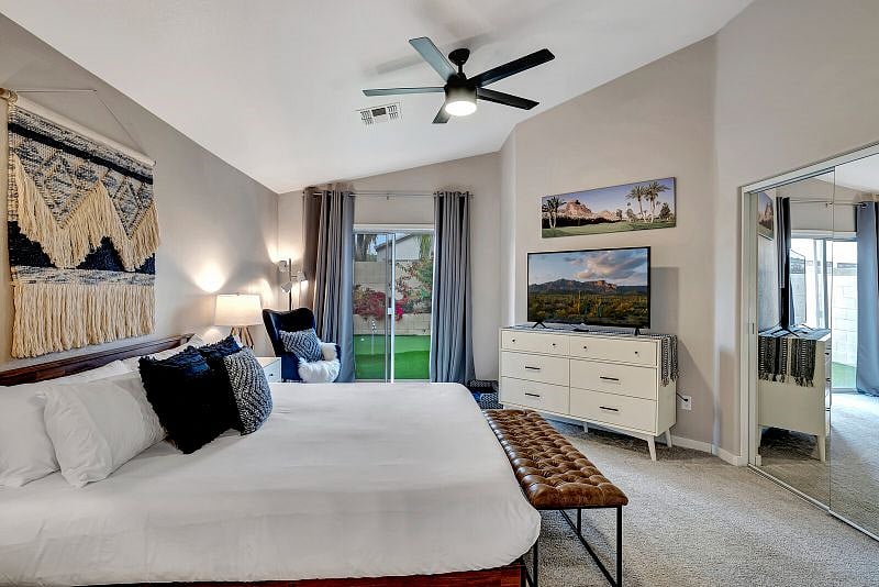 King bedroom with 60" Smart TV with ROKU, backyard access, double closets, and ensuite bathroom.