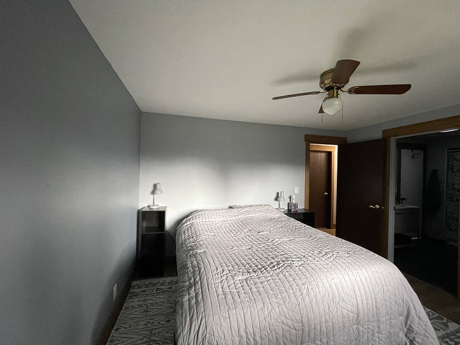 Master bedroom lit by the setting sun through west facing window. 