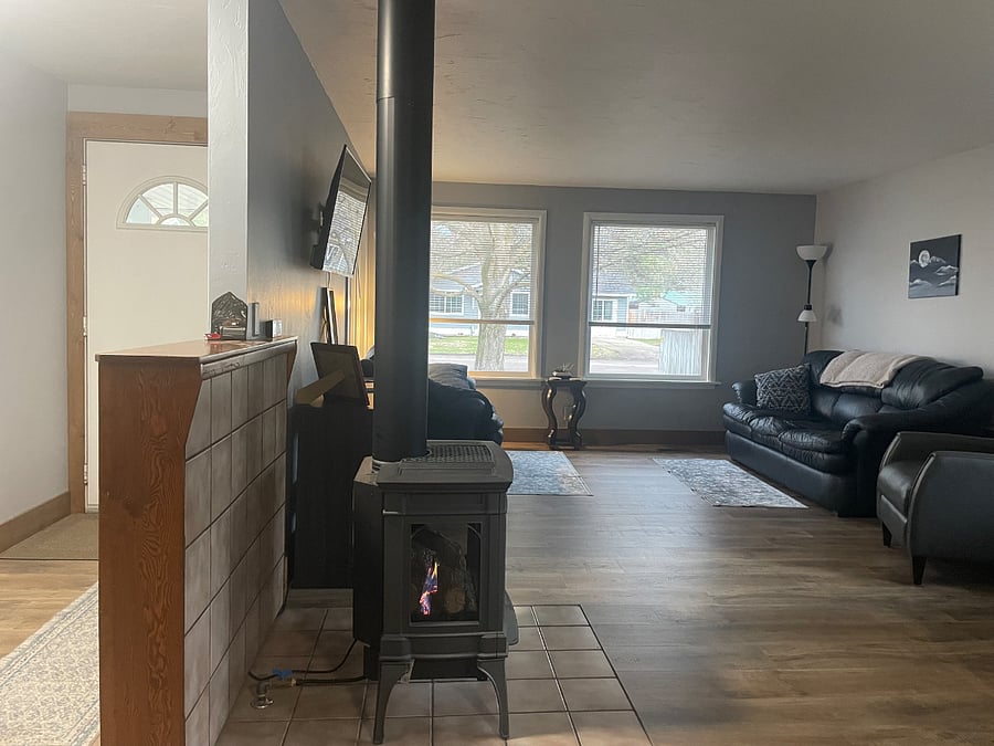 Front door and living room area. Dogs appreciate the view from the low windows.